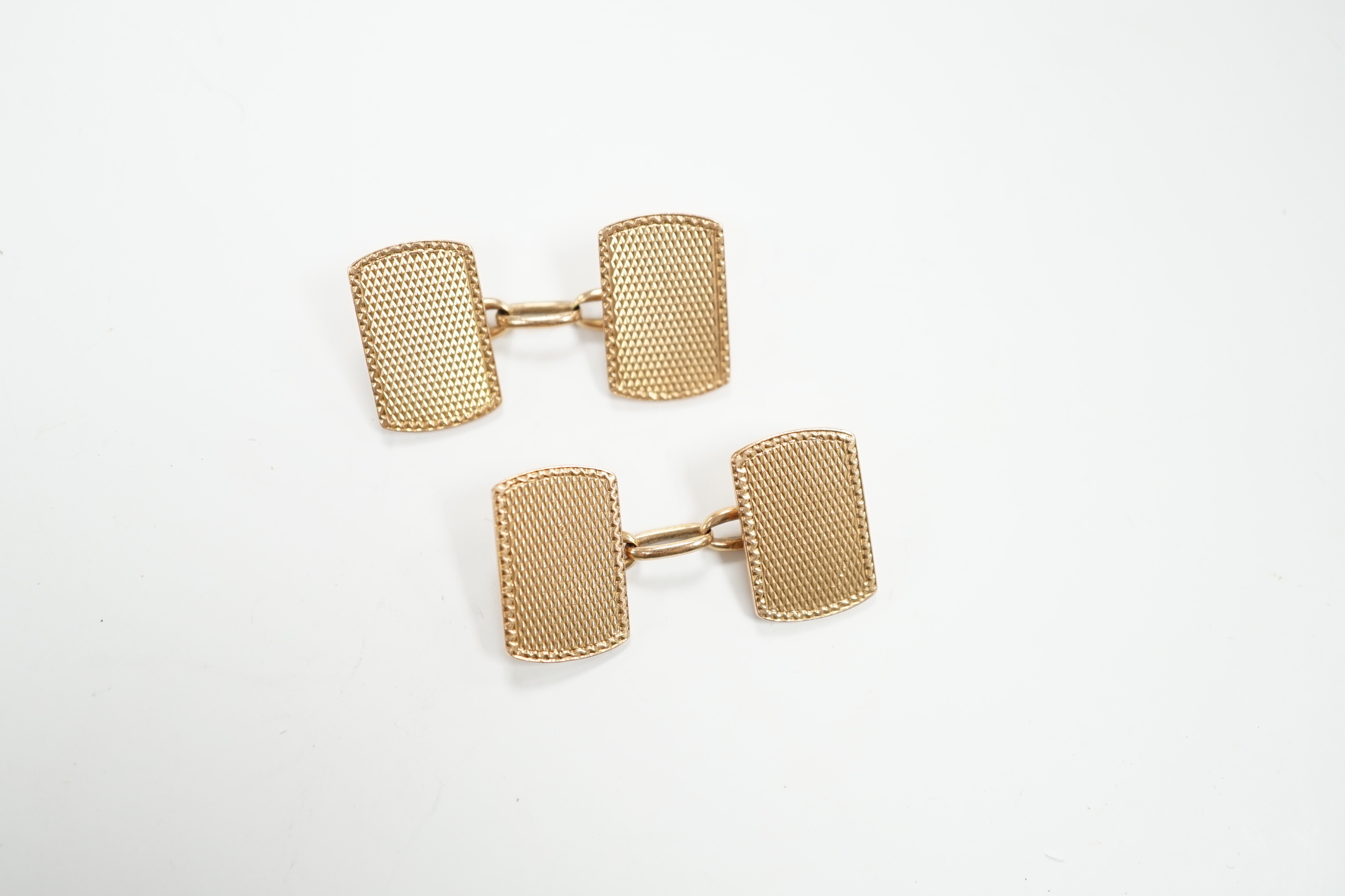 A pair of 1930's engine turned 9ct gold rounded rectangular cufflinks, 16mm, 8.8 grams.